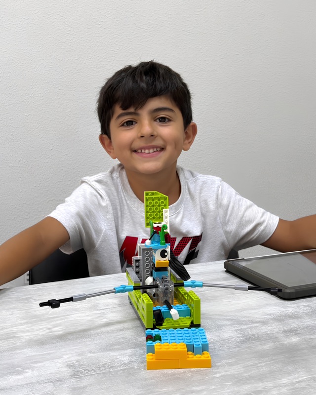 Young RoboStars student with a first foundational robotics build